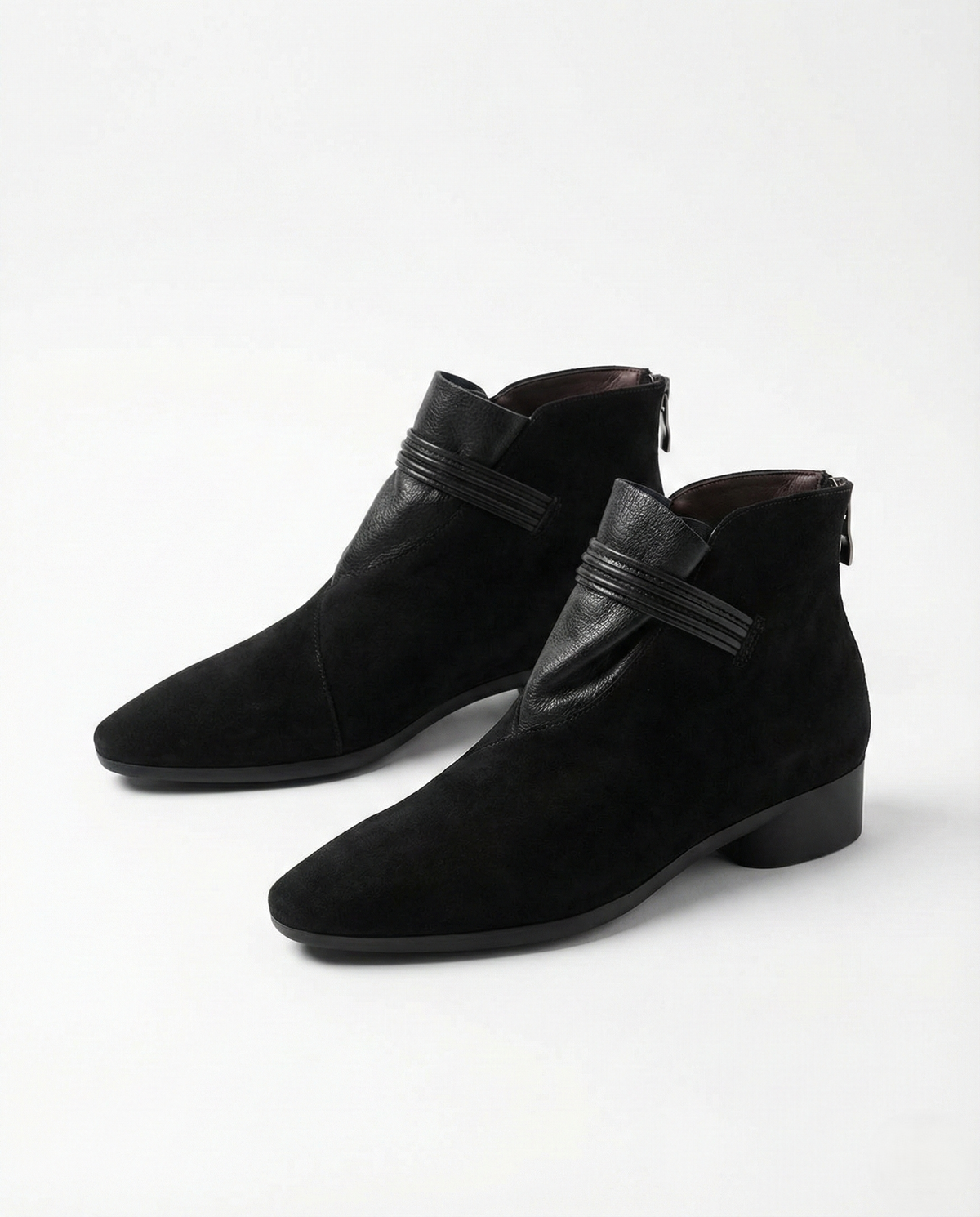 A side view of a pointed toe ankle boot with a decorative strap detail and low block heel._31