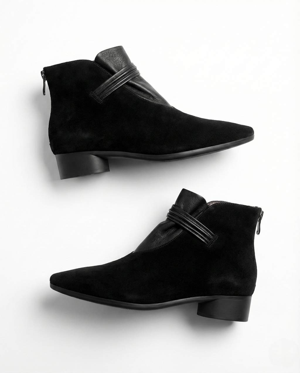 A side view of a pointed toe ankle boot with a decorative strap detail and low block heel._32