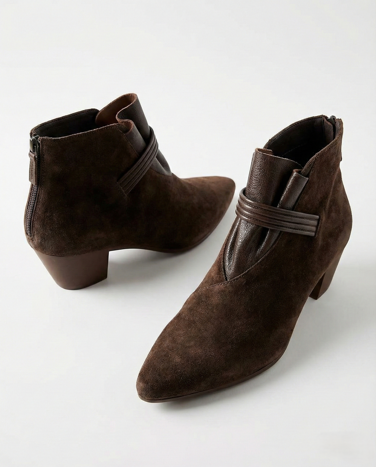 A side view of a pointed toe ankle boot with a decorative strap detail and low block heel._33