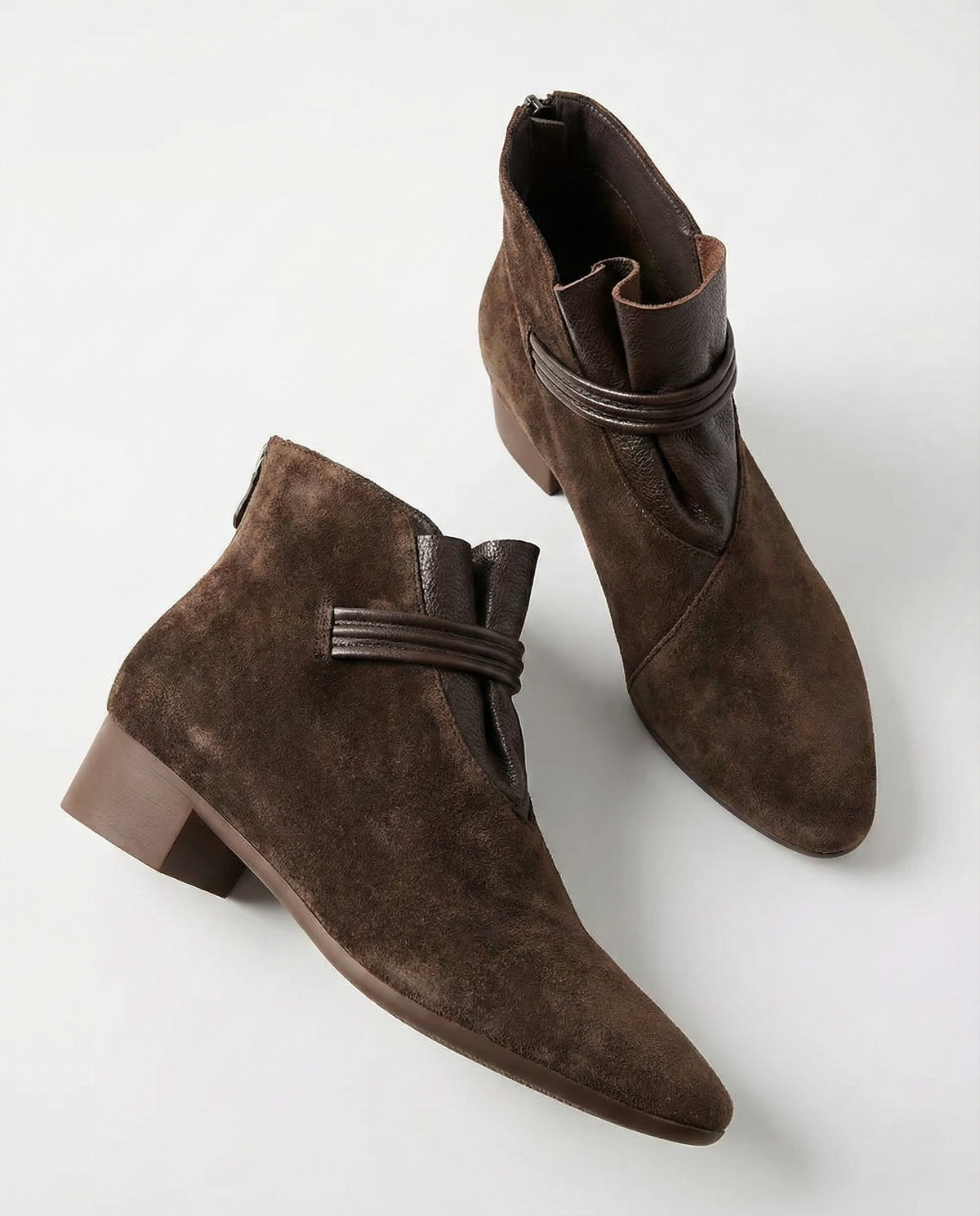 A side view of a pointed toe ankle boot with a decorative strap detail and low block heel._34