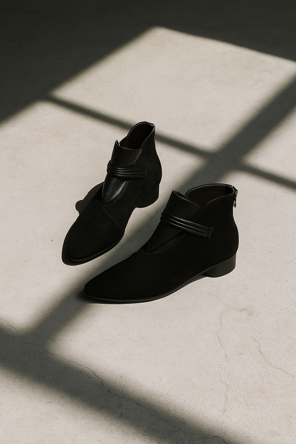 A side view of a pointed toe ankle boot with a decorative strap detail and low block heel._9