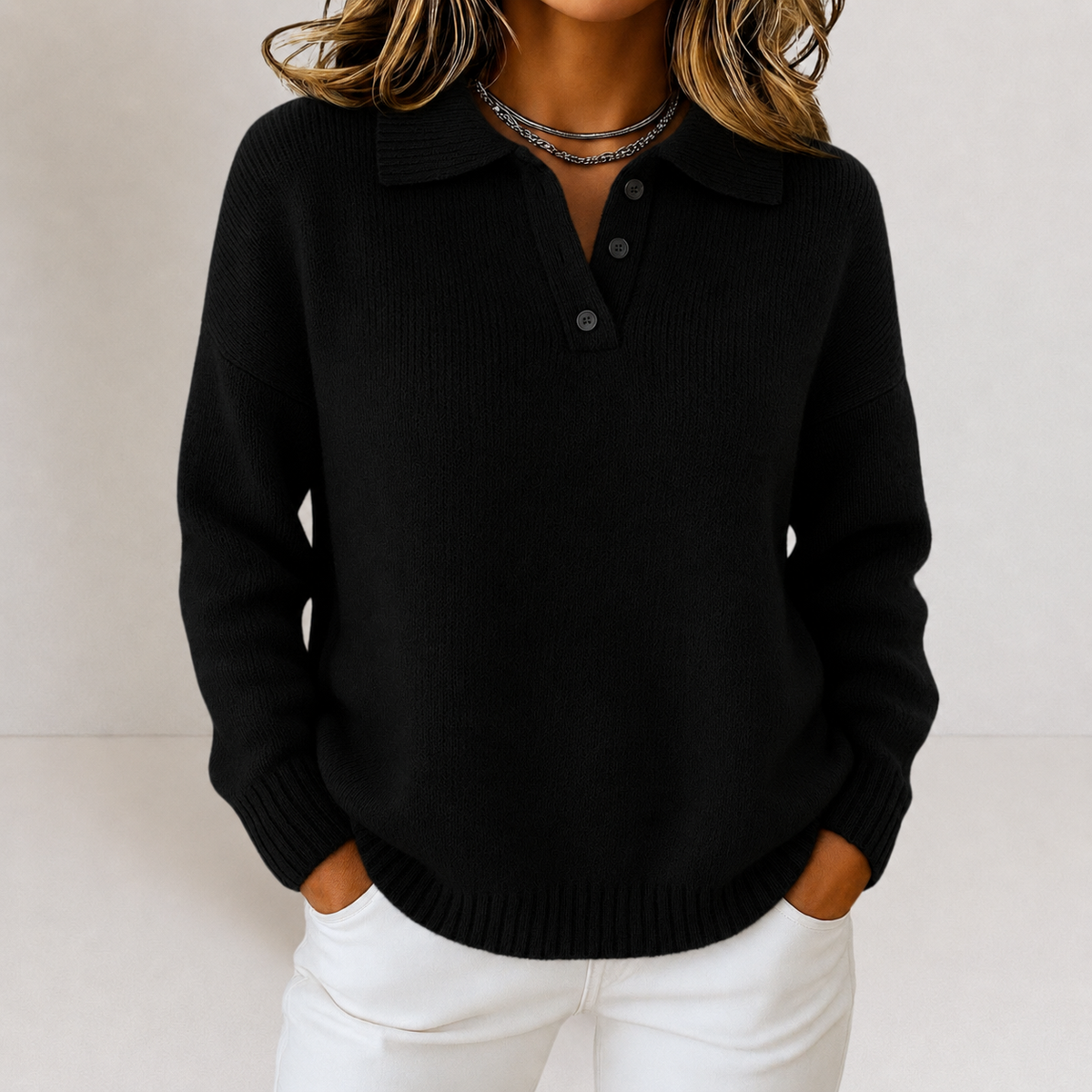 Black polo collar sweater with a button placket, long sleeves, and pronounced ribbing at the cuffs and hem.