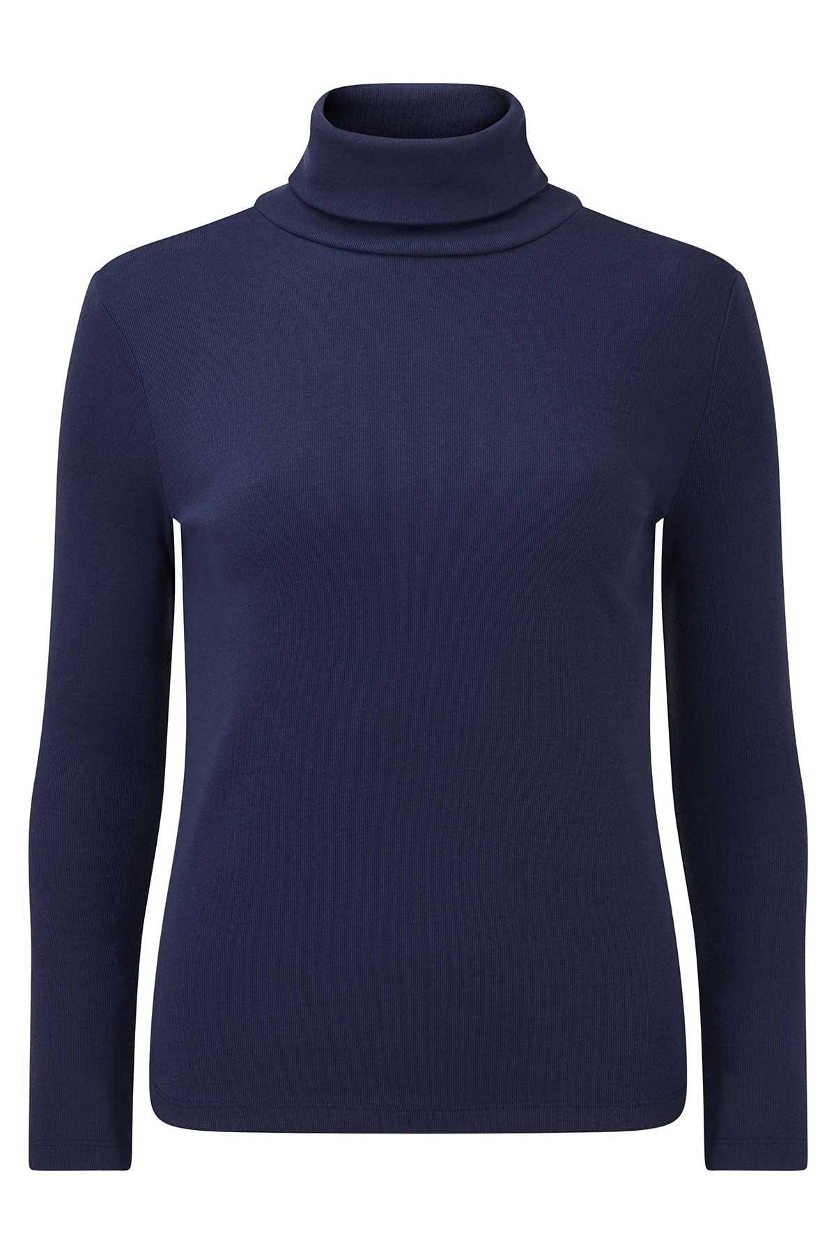 Woman wearing a beige long sleeve turtleneck top with buttoned cuffs and blue jeans against an olive backdrop._4