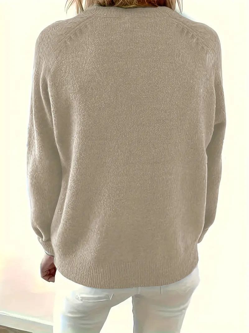 Woman wearing a sea green long-sleeve knit sweater with a stand collar, half-button placket with dark buttons and ribbed cuffs, paired with cream trousers._5