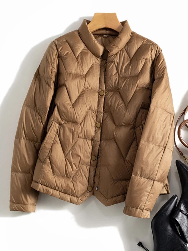 Woman wearing a quilted jacket with chevron stitching and snap button front closure._10