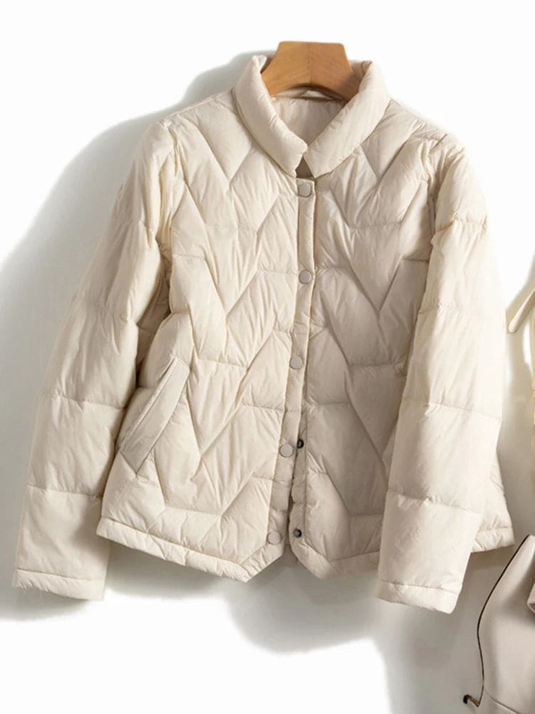 Woman wearing a quilted jacket with chevron stitching and snap button front closure._11