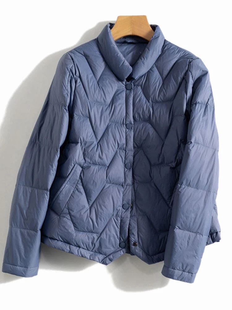 Woman wearing a quilted jacket with chevron stitching and snap button front closure._12