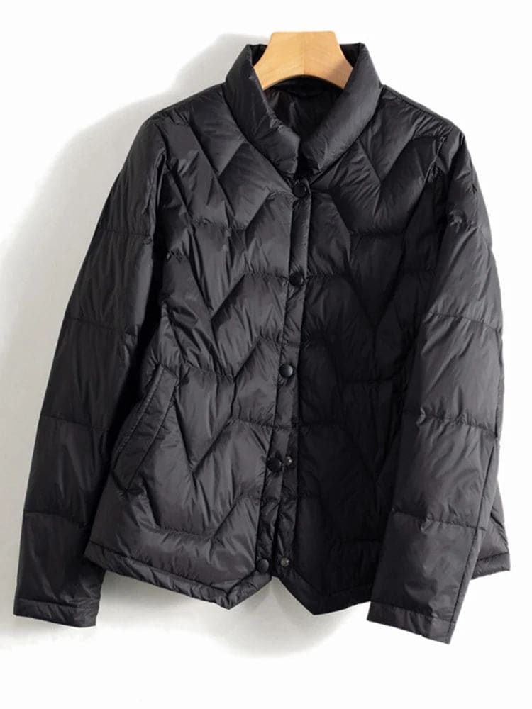 Woman wearing a quilted jacket with chevron stitching and snap button front closure._13