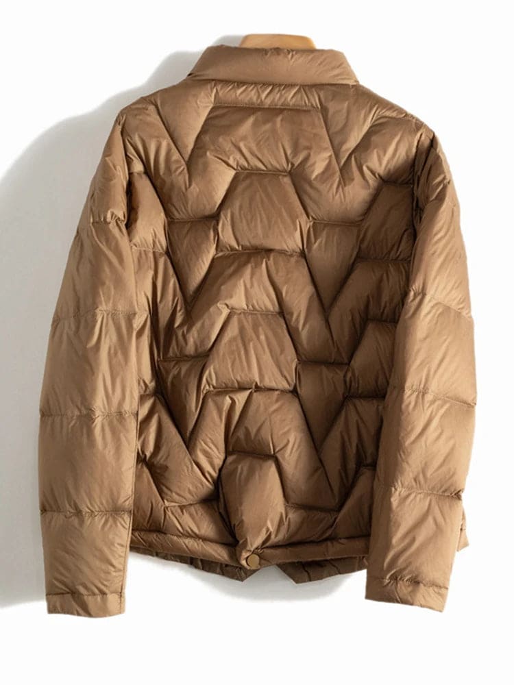 Woman wearing a quilted jacket with chevron stitching and snap button front closure._14