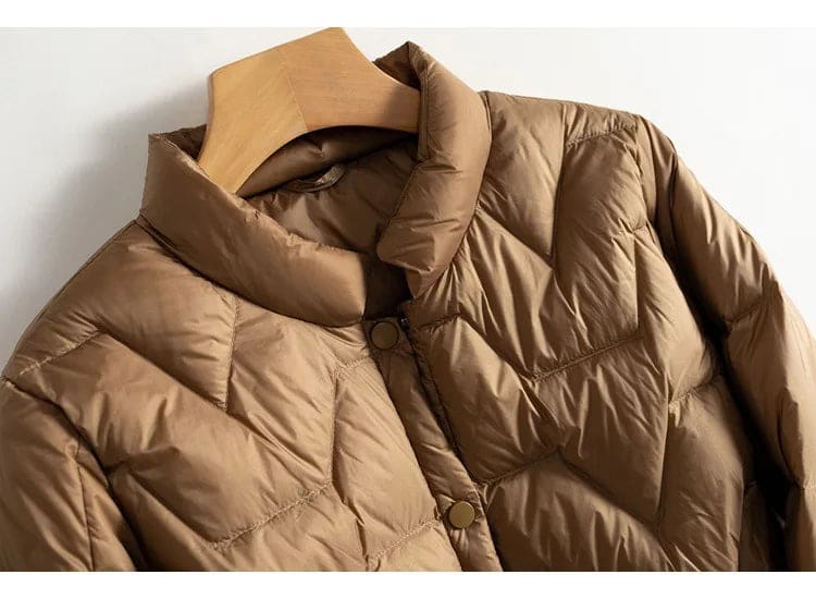 Woman wearing a quilted jacket with chevron stitching and snap button front closure._15