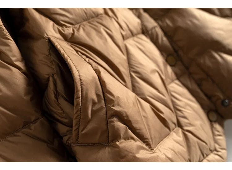 Woman wearing a quilted jacket with chevron stitching and snap button front closure._16