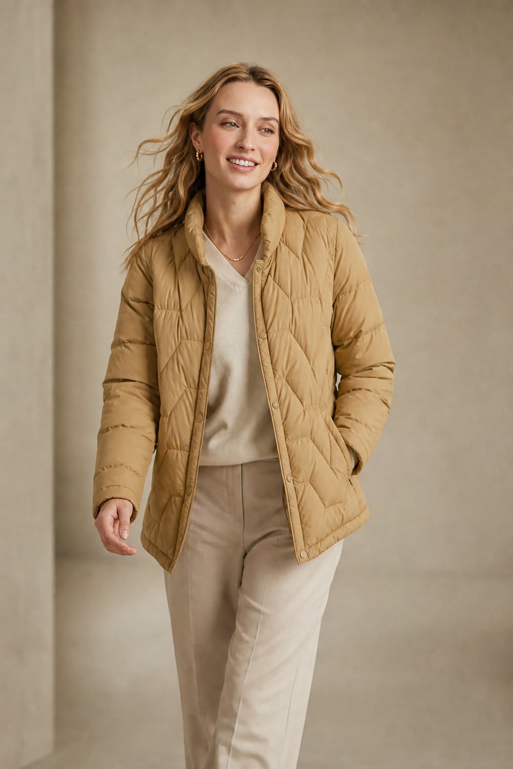 Woman wearing a quilted jacket with chevron stitching and snap button front closure._8
