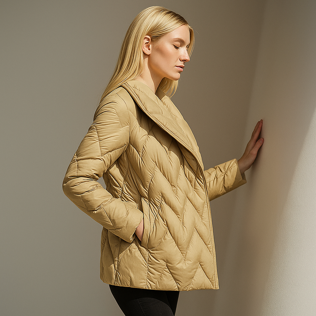 Woman wearing a quilted jacket with wrap front and tie belt in a warm neutral tone._39