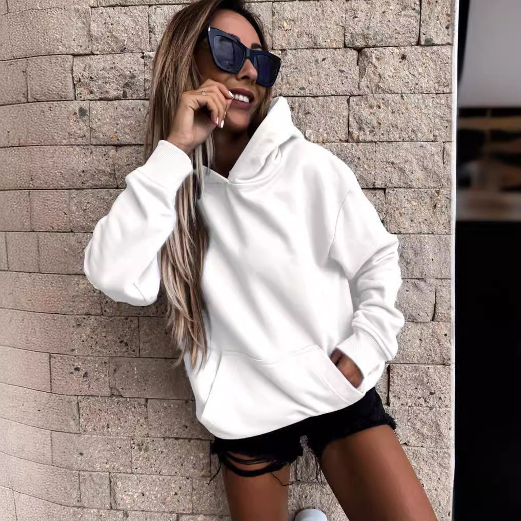 White pullover hoodie shown from the front, featuring a raised hood, relaxed sleeves, and a spacious front pocket.