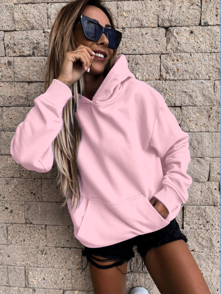 Pink hoodie displayed in a cropped front view, highlighting its roomy hood and kangaroo-style front pocket.