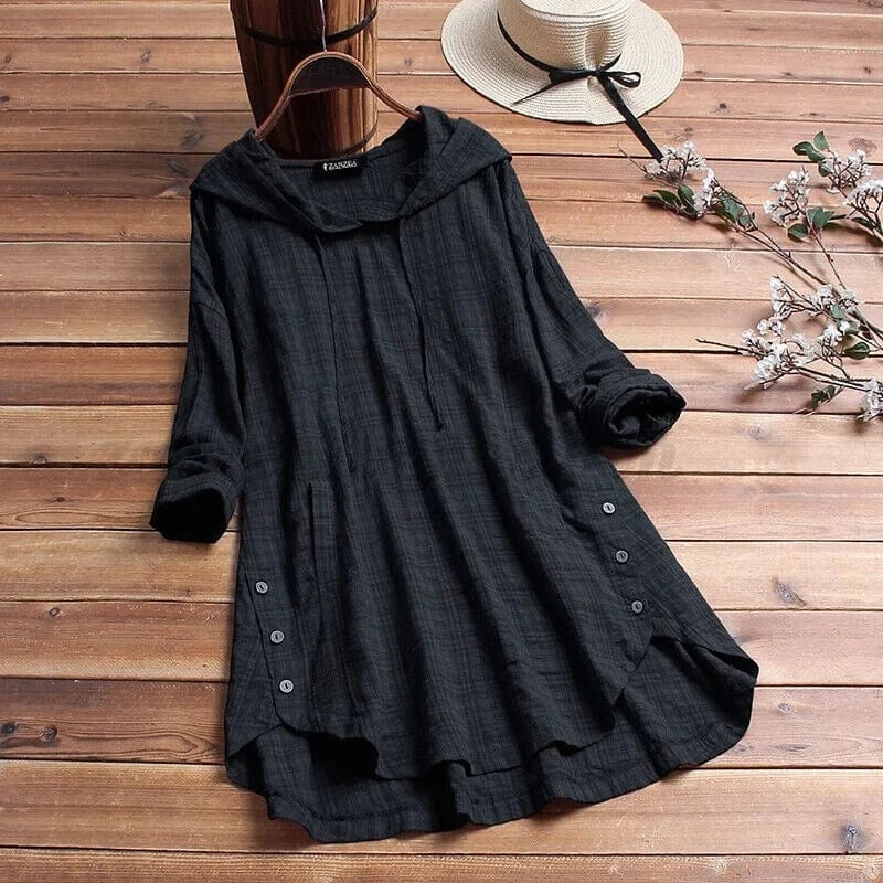 Black relaxed longline tunic hoodie with a softly gathered hood, long sleeves, side button accents, and an asymmetrical flowing hem.