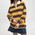 Model wearing a relaxed long sleeve rugby shirt with wide horizontal stripes, a contrast collar, and a partial button placket._0