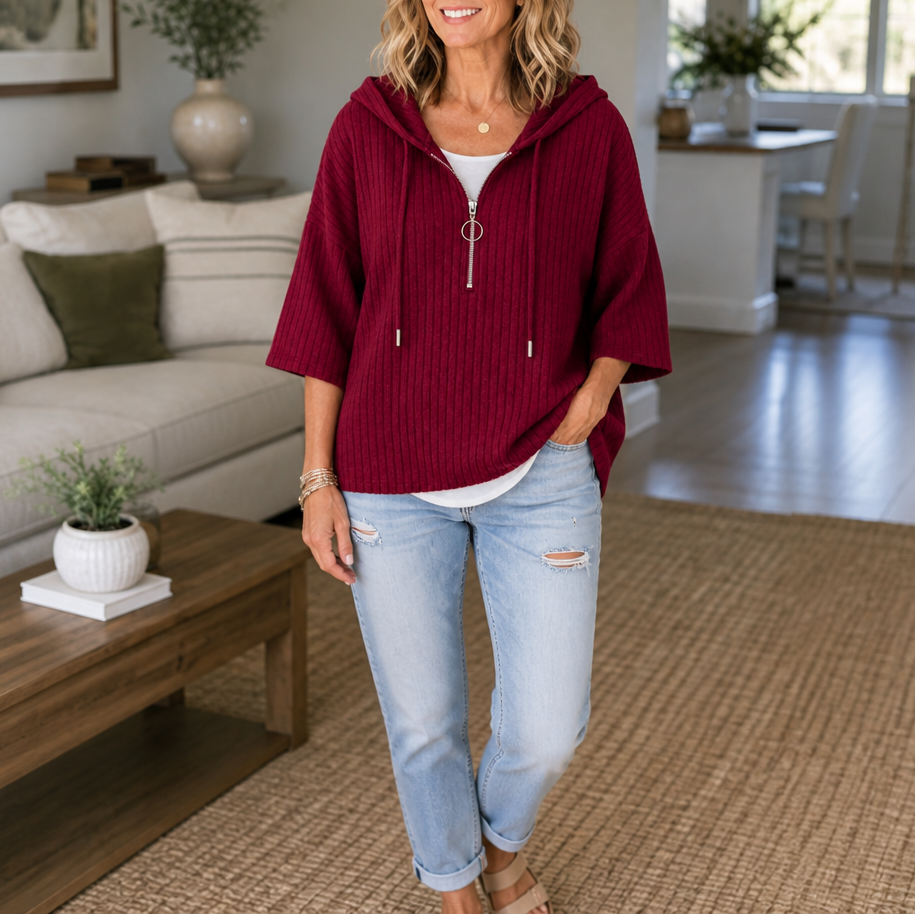 Burgundy ribbed half-zip hooded top paired with cuffed jeans.