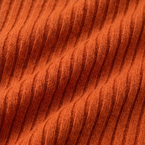 Macro view highlighting the raised vertical ribbed texture of the orange top.