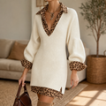 Close view of the cream ribbed mini dress with leopard-print collar, V-neck trim, turned-up cuffs, and hem.