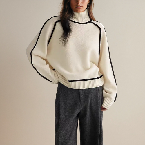 Woman wearing a beige turtleneck sweater with black contrast trim, styled with dark trousers and a black belt._1