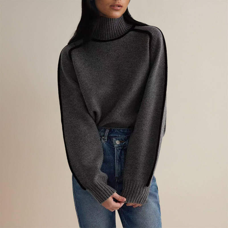 Woman wearing a beige turtleneck sweater with black contrast trim, styled with dark trousers and a black belt._3