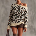 Woman wearing a cream leopard print off-shoulder knit sweater with ribbed cuffs and hem, brown shorts and tall boots._0