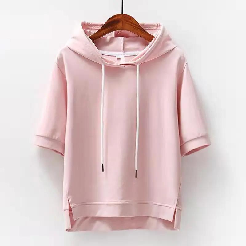 Pink short sleeve hooded top with white drawstring, cuffed sleeves and side slits on a wooden hanger._0