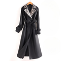 Black long trench coat with leopard print lapels, a belted waist, and cuffed sleeves shown on a hanger._0
