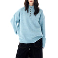 A model wears a relaxed fit mock neck Henley sweater with a buttoned neckline and ribbed hem._0