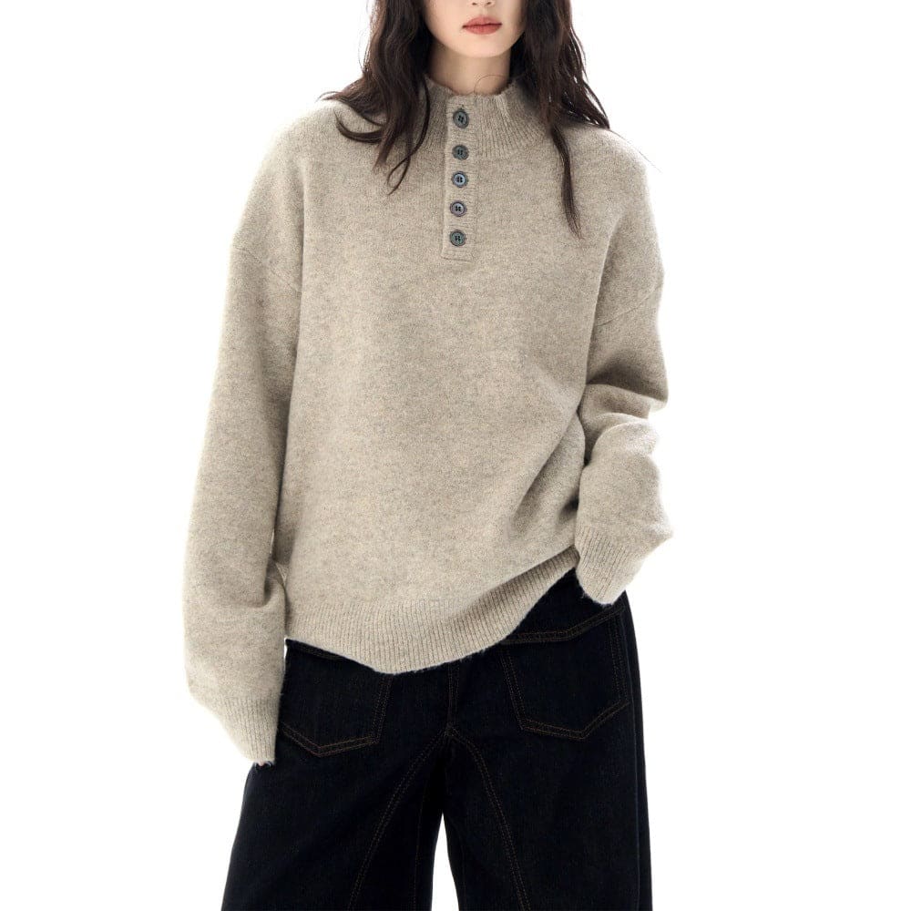 A model wears a relaxed fit mock neck Henley sweater with a buttoned neckline and ribbed hem._5