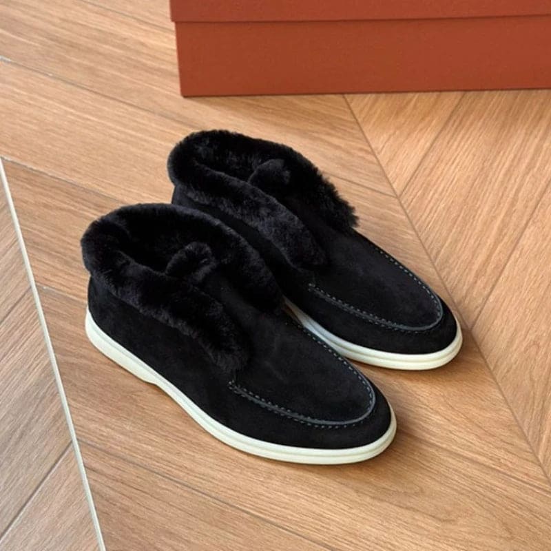 Side view of a shearling lined loafer boot in amber with white fur trim and a cream sole._18