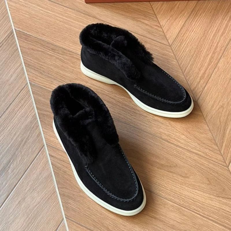 Side view of a shearling lined loafer boot in amber with white fur trim and a cream sole._19