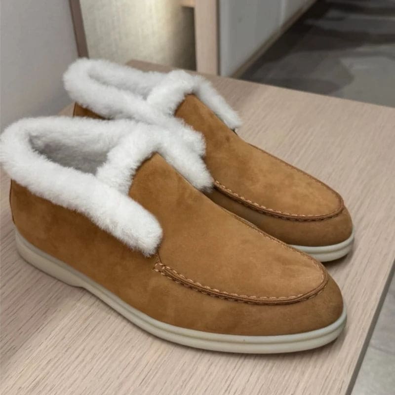 Side view of a shearling lined loafer boot in amber with white fur trim and a cream sole._21