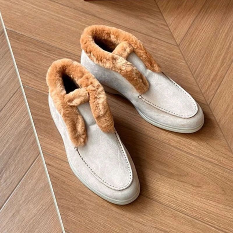 Side view of a shearling lined loafer boot in amber with white fur trim and a cream sole._23