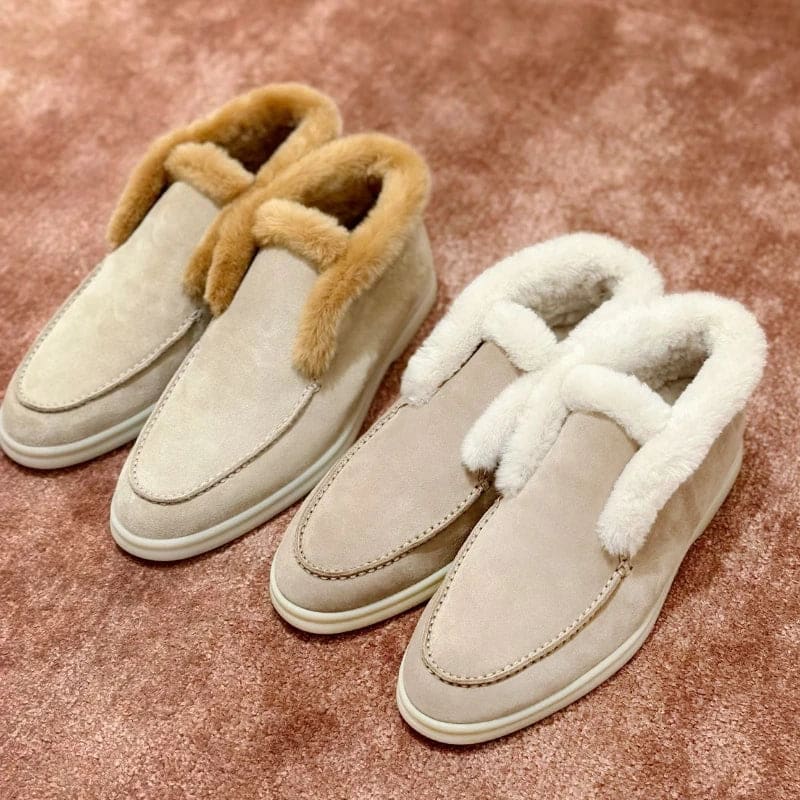 Side view of a shearling lined loafer boot in amber with white fur trim and a cream sole._24