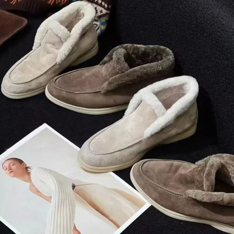 Side view of a shearling lined loafer boot in amber with white fur trim and a cream sole._25