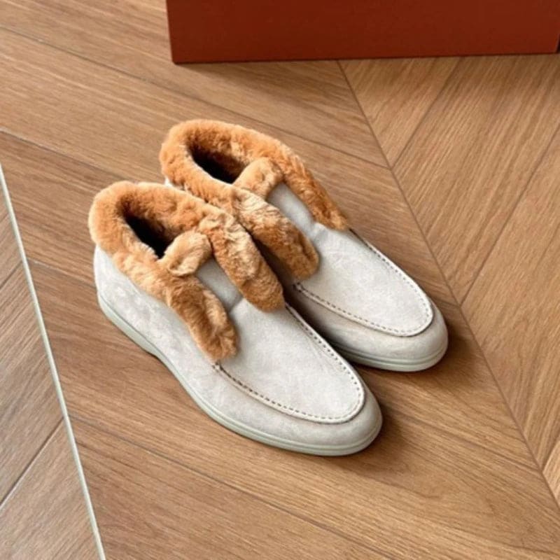 Side view of a shearling lined loafer boot in amber with white fur trim and a cream sole._27
