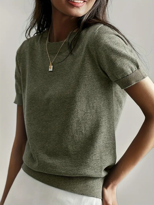 Olive green short sleeve crew neck sweater shown at a slight angle, highlighting the ribbed waistband.
