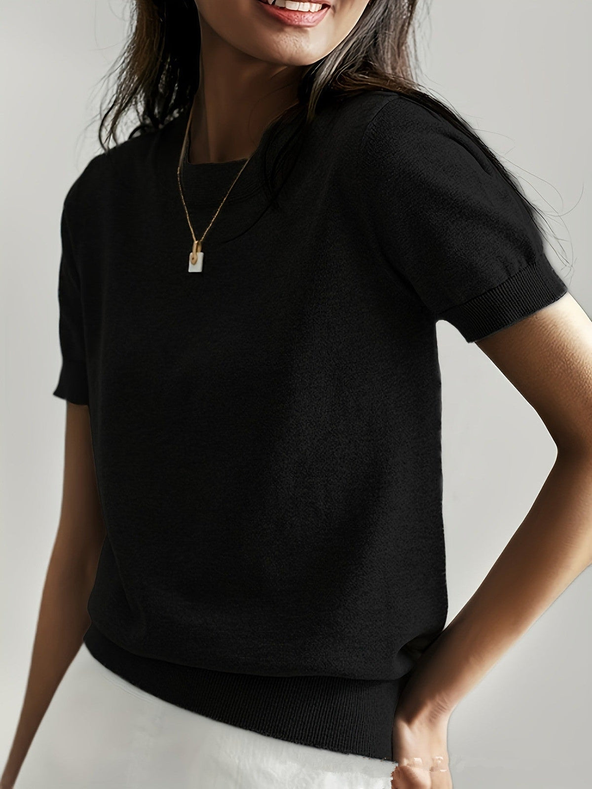 Black short sleeve crew neck sweater shown at a slightly different angle, emphasizing the clean crew neckline and short sleeves.