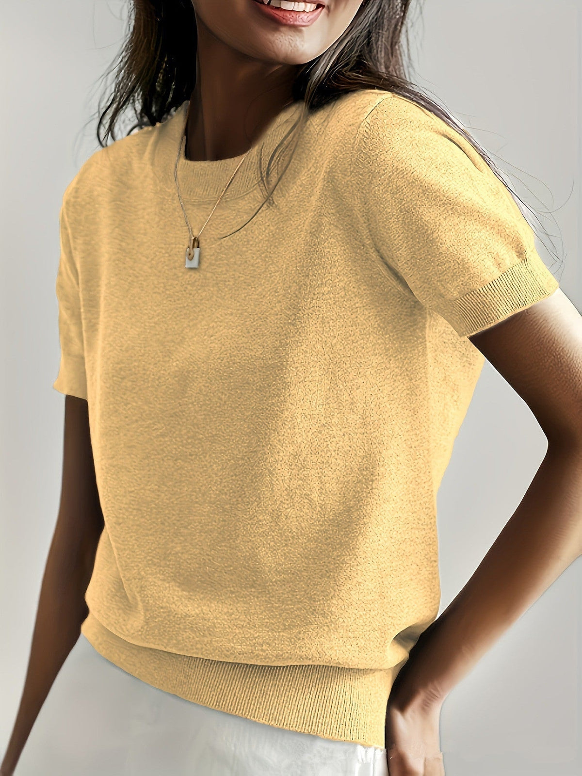 Yellow short sleeve crew neck sweater shown from the front, with ribbed cuffs and waistband.