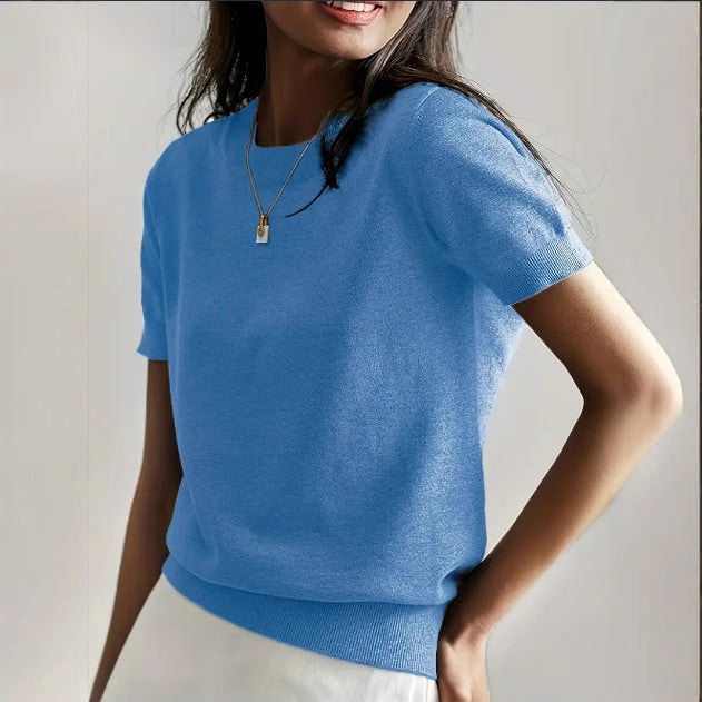 Bright blue short sleeve crew neck sweater displayed on a model, highlighting its relaxed short sleeves.