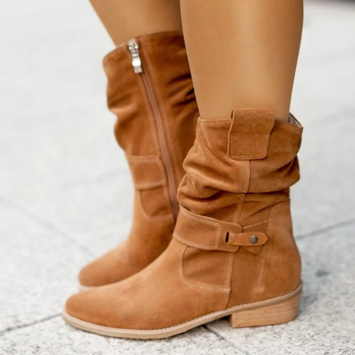 Tan boots shown from the outer side, clearly displaying the full mid-calf height, ankle buckle, side zipper, and flat heel.
