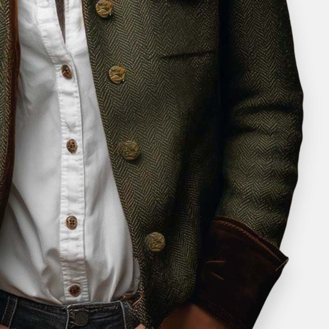 Woman wearing a structured herringbone jacket with contrast brown cuffs, chest pockets, and button-front closure, layered over a white shirt and jeans._1
