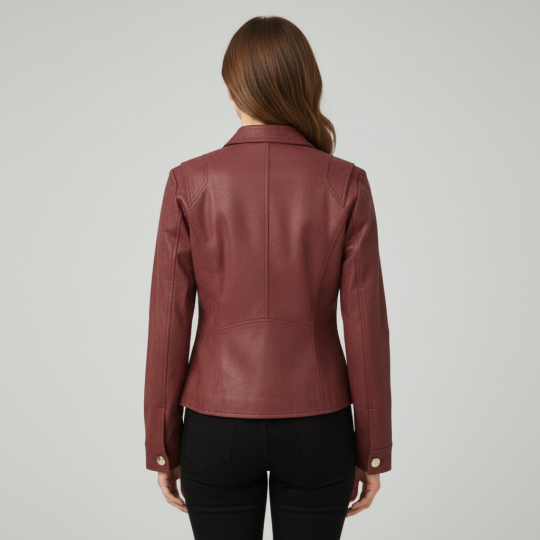 Woman wearing a cropped military-style jacket with gold button detail and stand collar, styled over a black top and pants._1
