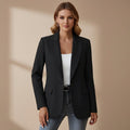 Woman wearing a black tailored blazer with notched lapel and front pockets over a white top and jeans._0