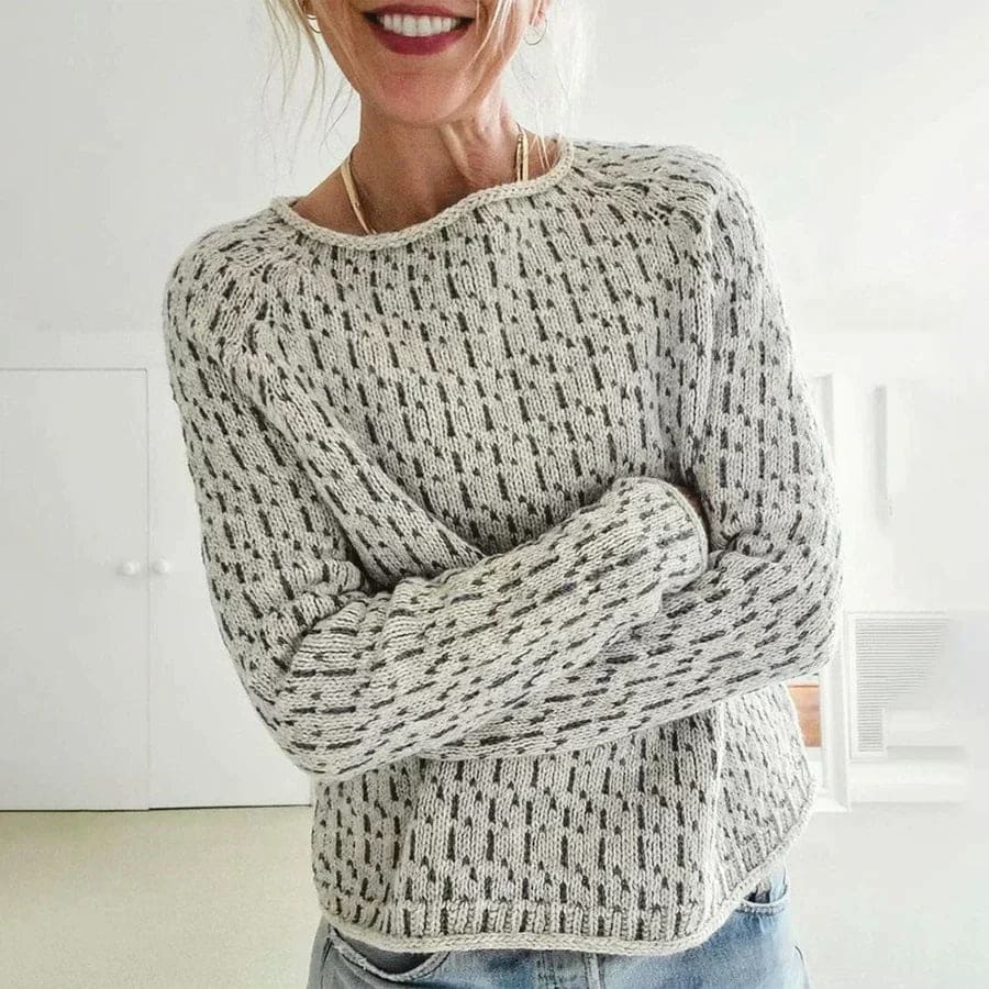 Woman wearing a relaxed fit crew neck sweater with textured knit pattern and ribbed detailing in a neutral tone._0