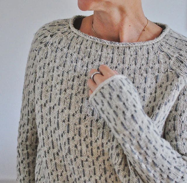 Woman wearing a relaxed fit crew neck sweater with textured knit pattern and ribbed detailing in a neutral tone._2