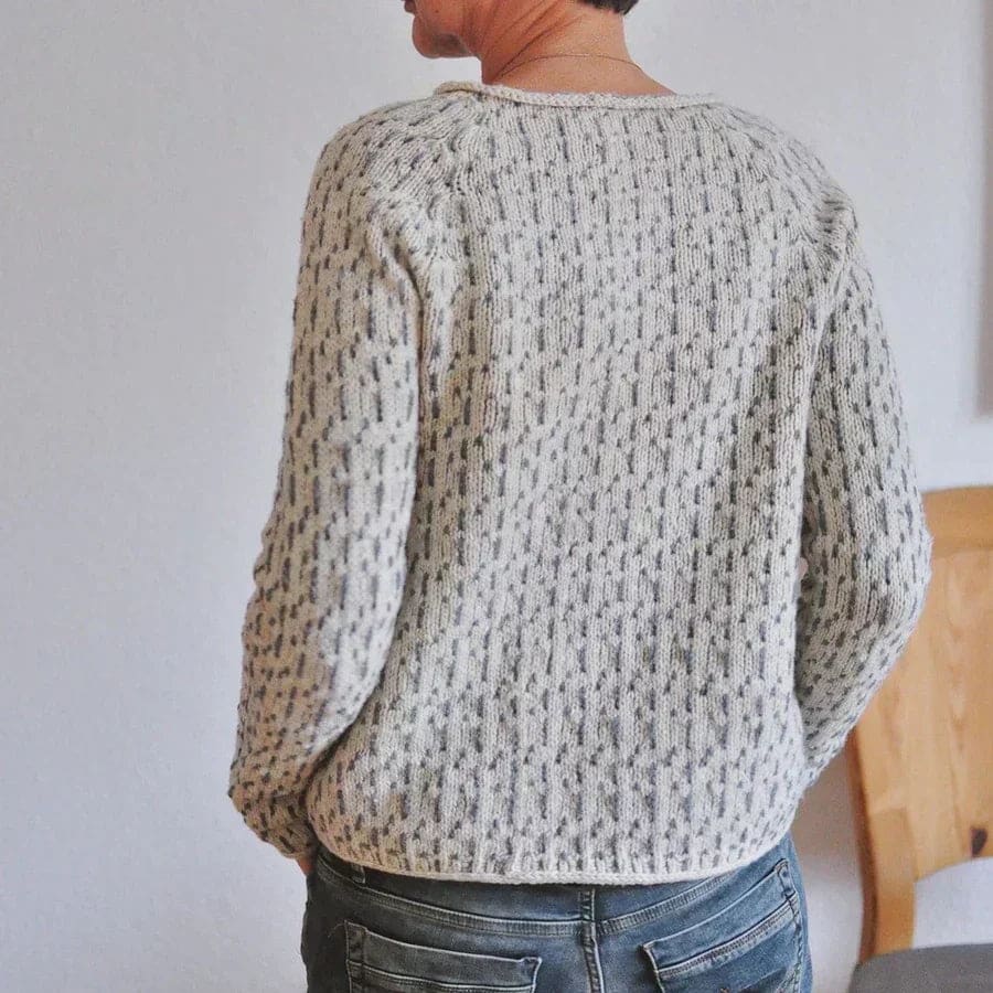 Woman wearing a relaxed fit crew neck sweater with textured knit pattern and ribbed detailing in a neutral tone._4