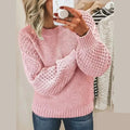 Woman wearing a textured knit sweater with crew neckline and open-stitch sleeve detailing._0
